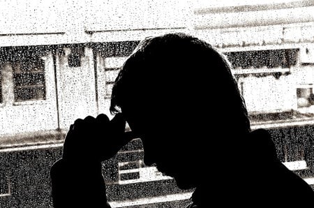 Silhouette of a grieving man