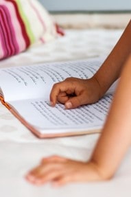 Child reading Hebrew book