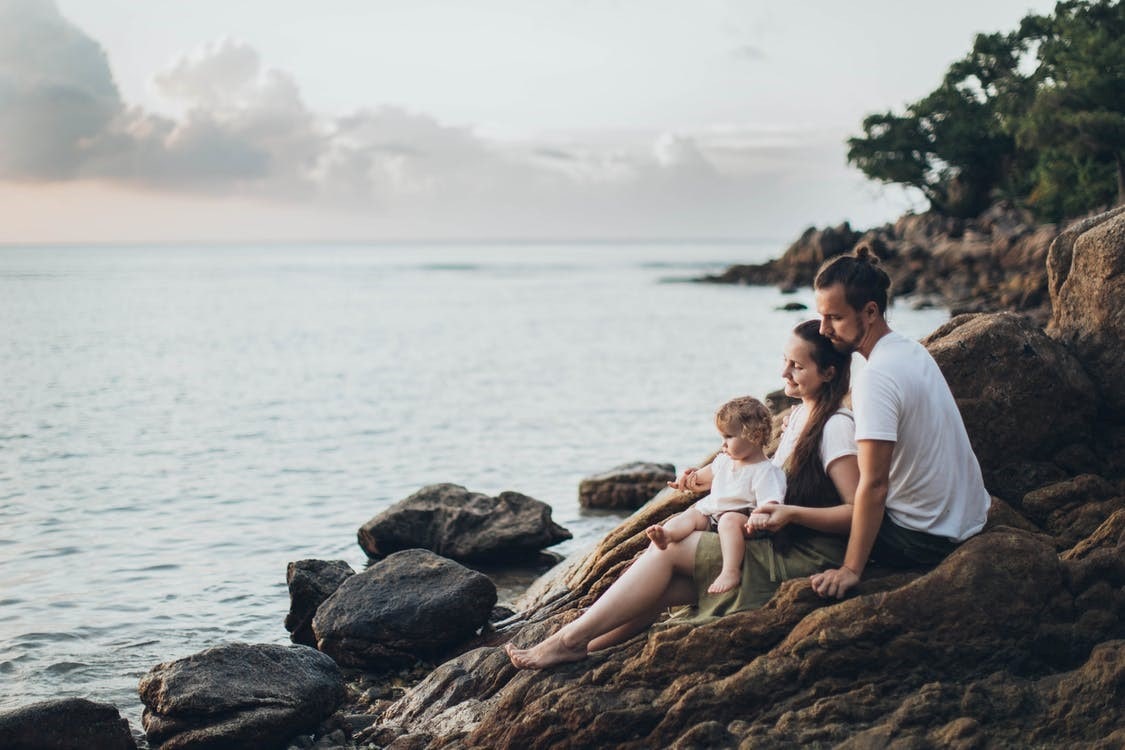 A family sitting together on the rocks
