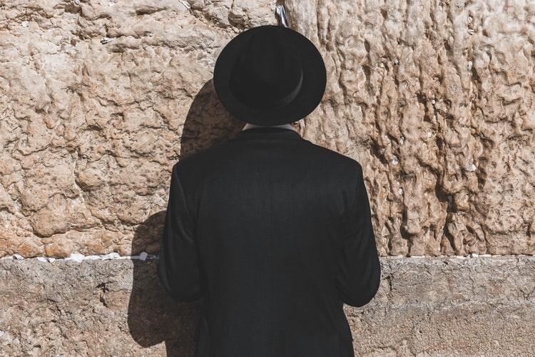 Jewish devotee facing the Western Wall in Jerusalem