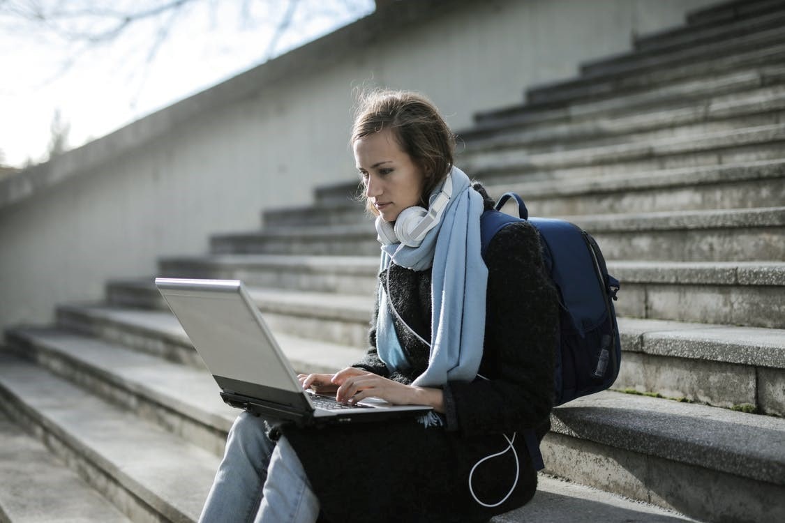 A university student using her laptop outdoors